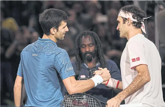  ??  ?? Novak Djokovic, left, and Roger Federer shake hands at the end of their semi-final in Paris last week.