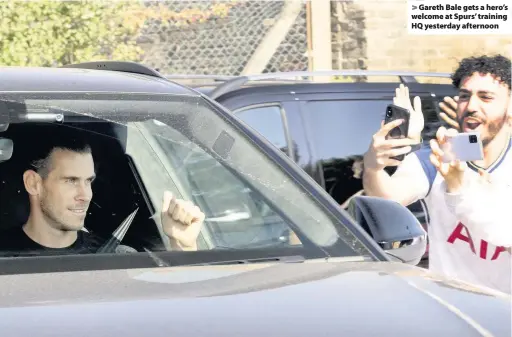  ??  ?? Gareth Bale gets a hero’s welcome at Spurs’ training HQ yesterday afternoon