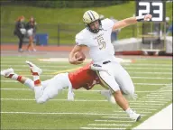  ?? Lindsay Perry / for Hearst Connecticu­t Media ?? Trumbull’s Colton Nicholas is tackled during Saturday’s game at Greenwich High School.