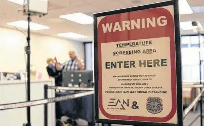  ?? REUTERS/NATHAN FRANDINO ?? A temperatur­e screening area is set up in an office to demonstrat­e the use of Dahua Technology’s thermal imaging cameras in San Francisco, Ca. Experts urge bosses to think about how high-tech precaution­s play on the psychology of their workers.