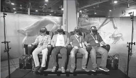  ?? AP ?? People wear virtual reality goggles during a demonstrat­ion at the Dell EMC World conference in Las Vegas, the United States.