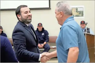  ?? Jeremy stewart ?? Cedartown City Manager Edward Guzman, seen here greeting city public works employee Jerry W. Jackson at a recent commission meeting, is looking forward to 2023 as a year of action for the city.