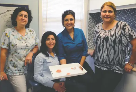  ?? [WHITNEY NEILSON / THE OBSERVER] ?? Akram Ghassemiya­n (right) joins the Elmira Denture Clinic this week, which is open on Thursdays. She also works at the Waterloo Denture Clinic the rest of the week with Marisa Redondo, Shakila Shah and Vinolea Jahandari.