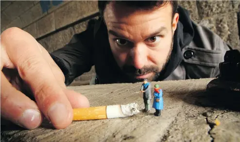  ?? — TINY GOAT FILMS ?? An artist who goes by ‘Slinkachu’ shows off just how tiny his work is in the documentar­y Miniatures.