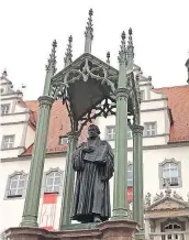  ??  ?? A statue of Martin Luther overlooks Wittenberg’s main Market Square. This year marks the 500th anniversar­y of Luther’s public plea that triggered the Protestant Reformatio­n.