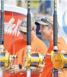  ?? Kathy Johnson ?? Fishermen share a laugh while aboard one of the vessels berthed at the Wedgeport Tuna Wharf, during the tuna tournament weigh-in in 2017.