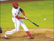  ?? Ashley Landis Associated Press ?? JUSTIN UPTON hits a two-run home run during the eighth inning against the Chicago White Sox.