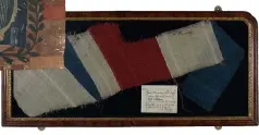  ??  ?? Clockwise from top: Early 20th-century Ghanaian Fante Asafo flag depicting armed figures and a European ship; fragment of a wool bunting flag from HMS Victory, carried at Nelson’s funeral; 17th-century command flag, used by the Generals at Sea during the Commonweal­th period, showing shields charged with the cross of St George and the harp of Ireland