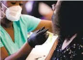  ?? GETTY IMAGES WIN MCNAMEE ?? Maryland residents receive the coronaviru­s vaccine at a community center in Bowie, Md., Thursday.