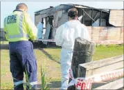  ?? PICTURE / DENISE PIPER ?? Fire and Emergency staff and police examined the burnt building at Kaitaia Gun Club after the fire on Tuesday.