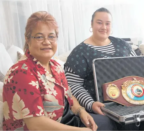  ??  ?? Joseph Parker’s mum, Sala, sister Elizabeth and dad, Dempsey, with the WBO belt that is on the line in Cardiff.
