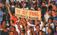  ?? REUTERS ?? People hold a sign reading in Spanish “I am Fidel” during a Saturday event commemorat­ing the first anniversar­y of the death of Cuban President Fidel Castro, in Havana. Cubans mourned Castro’s death with political and cultural events.