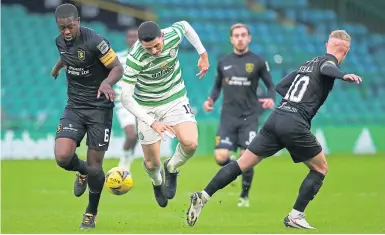  ??  ?? Tom Rogic battles for the ball with Livingston’s Marvin Bartley (left) and Craig Sibbald (right)