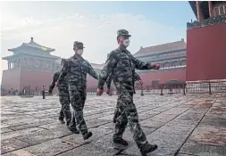  ?? NICOLAS ASFOURI AFP/TRIBUNE NEWS SERVICE ?? Soldiers march near the Forbidden City in Beijing on Thursday. New security laws threaten to erode freedoms that distinguis­h Hong Kong from the rest of China.