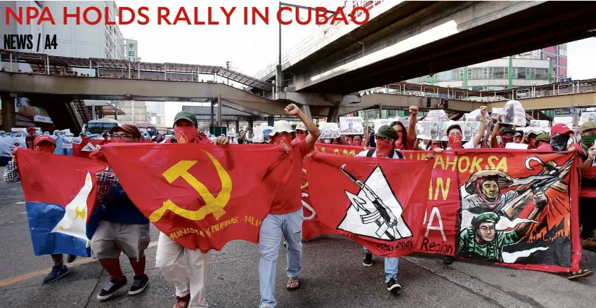  ?? —NIÑO JESUS ORBETA ?? OUT IN THE OPEN Members of the communist undergroun­d movement lead a lightning rally in Cubao, Quezon City, to mark the 48th anniversar­y of the New People’s Army.