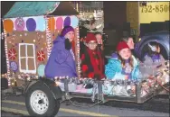  ?? Westside Eagle Observer/MIKE ECKELS ?? Mary Lou Janes (left) and the Decatur Girl Scouts ride their float in the Decatur Christmas Parade through downtown Decatur Dec. 7.