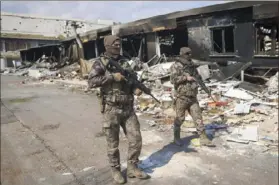  ?? ?? Turkish army soldiers patrol near destroyed buildings in Antakya, southeaste­rn Turkey on Tuesday.