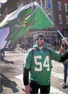  ?? GENE WALSH — DIGITAL FIRST MEDIA ?? Ryan Dadalski waves his Eagles Flag as he and other fans celebrate during the Victory Parade Thursday.