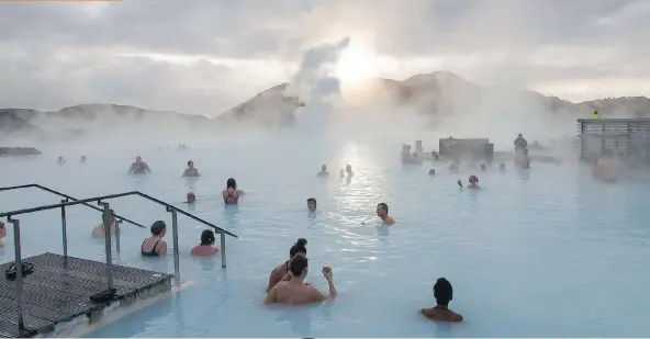  ?? ARNALDU HALLDORSSO­N/ WASHINGTON POST ?? Bathers relax in the Blue Lagoon geothermal spa in Grindavik, Iceland’s biggest attraction.