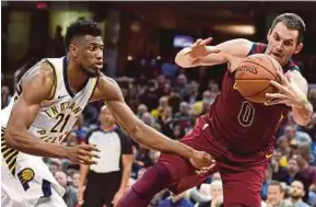  ?? REUTERS PIC ?? Cavaliers’ Kevin Love (right) and Indiana Pacers’ Thaddeus Young vie for the ball in their NBA match at Quicken Loans Arena in Cleveland, Ohio on Wednesday.