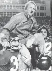  ??  ?? The Associated Press file Arkansas football coach Frank Broyles is carried from the field following a 1975 victory over Texas A&M. Broyles, who guided Arkansas to its lone national football title, died Monday.