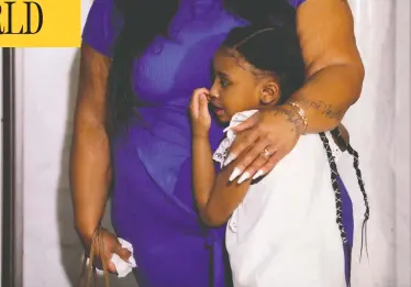  ?? LUCAS JACKSON / REUTERS ?? George Floyd’s six-year-old daughter Gianna is embraced by her mother Roxie Washington before speaking about her father at Minneapoli­s City Hall on Tuesday. Floyd died in police custody last week.