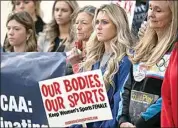  ?? DARREN ABATE / AP ?? Former University of Kentucky swimmer Riley Gaines, second from right, stands during a rally on Jan. 12, 2023, outside of the NCAA Convention in San Antonio.