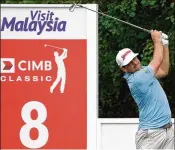  ?? STANLEY CHOU / GETTY IMAGES ?? Keegan Bradley eyes a shot during his 7-under 65 at the CIMB Classic in Kuala Lumpur. Bradley was tied with fellow American Xander Schauffele and Poom Saksansin of Thailand for second.