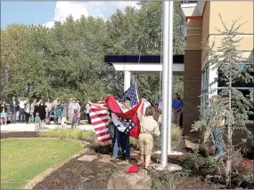  ?? LYNN KUTTER ENTERPRISE-LEADER ?? Prairie Grove’s Boy Scout Troop posted the colors for the grand opening last week at Arvest Bank.