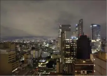  ?? REBECCA BLACKWELL - THE ASSOCIATED PRESS ?? A general view of Mexico City after an earthquake, in the early morning hours of Friday. Officials said a massive 8.1-magnitude earthquake hit off Mexico’s southern coast, toppling houses in Chiapas state, causing dozens of deaths and setting off a...