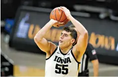  ?? AP Photo/Charlie Neibergall ?? Iowa center Luka Garza shoots against Western Illinois on Thursday in Iowa City, Iowa. Garza scored 35 points as Iowa won, 99-58.