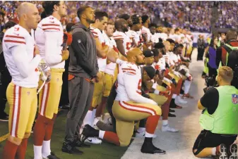  ?? Michael Conroy / Associated Press 2017 ?? Several 49ers kneel during the national anthem before their game against the Colts in Indianapol­is on Oct. 8. Vice President Mike Pence, who was at the game, left after the protest.