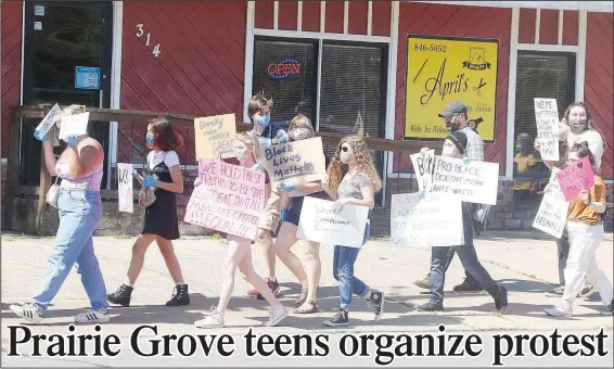  ?? (NWA Democrat-Gazette/Lynn Kutter) ?? Protesters supporting the Black Lives Matter movement march in Prairie Grove last week.