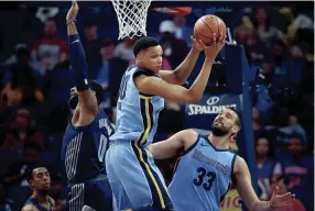  ??  ?? Memphis Grizzlies forward Ivan Rabb (10) picks up a rebound under pressure by Detroit Piston's center Andre Drummond (0) during their NBA game Sunday April 8, 2018 at the FedExForum. JIM WEBER/THE COMMERCIAL APPEAL