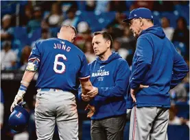  ?? Julio Aguilar/getty Images ?? Rangers infielder Josh Jung will be out for an indefinite amount of time after his right wrist was broken by a pitch from Rays reliever Phil Maton in Monday’s game.