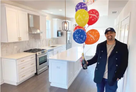  ?? PROVIDED ?? Phillip Sinclair celebrates closing on his new home in Woodlawn earlier this month. An artist known as “P. Scott” and the owner of Pilsen’s NYCH Gallery, Sinclair was able to buy his first home through JPMorgan Chase’s Path Forward initiative.