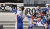  ?? GARY C. KLEIN / THE SHEBOYGAN PRESS ?? Alex Palou (left) takes a photo with teammates after winning last Sunday’s IndyCar race at Road America near Elkhart Lake, Wis.