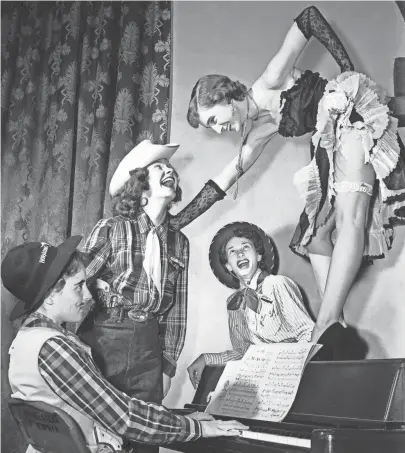  ?? THE COMMERCIAL APPEAL FILES ?? Can-can girl Viola Deavours of San Antonio, TX leads a trio of rugged cowpokes (Left to Right), Helen Coke of Caruthersv­ille, MO; Mary Taylor of Winston-Salem, NC and Ruth Faquin of 186 Mignon in a rousing chorus from a popular Western ditty. The scene occurred at Kappa Delta Sorority's “Pink Garter” Western-type cafe during sorority rush at Southweste­rn College on 27 Sep 1951.