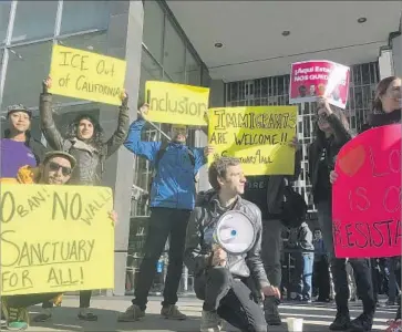  ?? Haven Daley Associated Press ?? PROTESTERS gather outside a San Francisco courthouse this month where a federal judge later blocked enforcemen­t of President Trump’s “sanctuary” city executive order, resting his ruling on high court decisions.