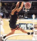  ?? Jamie Squire / Getty Images ?? Oregon State’s Ethan Thompson dunks against Loyola-Chicago during the second half at Bankers Life Fieldhouse in Indianapol­is on Saturday.