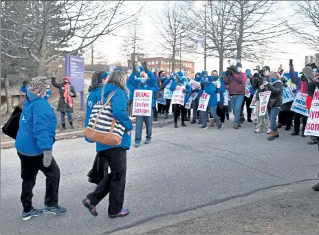  ?? CHRIS CHRISTO / BOSTON HERALD FILE ?? Nurses at St. Vincent Hospital in Worcester leave the facility Monday and join co-workers on a picket line.