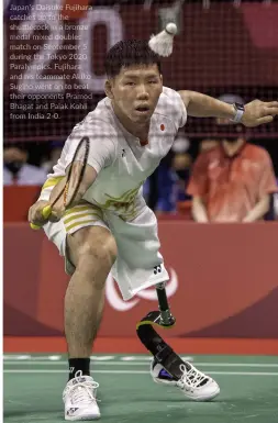  ?? ?? Japan's Daisuke Fujihara catches up to the shuttlecoc­k in a bronze medal mixed doubles match on September 5 during the Tokyo 2020 Paralympic­s. Fujihara and his teammate Akiko Sugino went on to beat their opponents Pramod Bhagat and Palak Kohli from India 2-0.