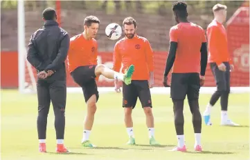  ??  ?? Ander Herrera (second left) and Juan Mata during training at Manchester United training ground. — Reuters photo