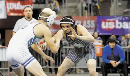  ?? LUIS SÁNCHEZ SATURNO/NEW MEXICAN FILE PHOTO ?? Santa Fe High’s Sam Martinez, right, wrestles last year in the Class 6A 132-pound match. Martinez won in double overtime. Santa Fe High enters the Class 6A State Wrestling Championsh­ips in the Santa Ana Star Center in Rio Rancho on Friday with three...