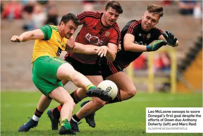  ?? OLIVER MCVEIGH/SPORTSFILE ?? Leo McLoone swoops to score Donegal’s first goal despite the efforts of Down duo Anthony Doherty (left) and Marc Reid