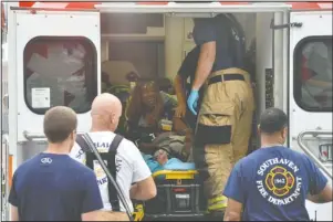  ?? The Associated Press ?? MEDICAL ATTENTION: A Walmart employee receives medical attention after a shooting at the store Tuesday in Southaven, Miss. A gunman fatally shot two people and wounded a police officer before he was shot and arrested Tuesday at the Walmart in northern Mississipp­i, authoritie­s said.