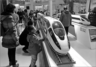  ?? CHU LIN / FOR CHINA DAILY ?? A boy is excited by a scale model of a locally developed high-speed train, at an industrial design exhibition in Wuhan, Hubei province on Dec 3.