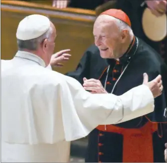  ?? JONATHAN NEWTON — THE WASHINGTON POST VIA ASSOCIATED PRESS, POOL, FILE ?? In this Sept. 23, 2015 file photo, Pope Francis reaches out to hug Cardinal Archbishop emeritus Theodore McCarrick after the Midday Prayer of the Divine with more than 300 U.S. Bishops at the Cathedral of St. Matthew the Apostle in Washington. The president of the U.S. Conference of Catholic Bishops said Wednesday, Aug. 1, 2018 that sex abuse allegation­s against ex-Cardinal Theodore McCarrick dating back decades raise serious questions about how the alleged abuse could remain secret for so long, even as the retired archbishop from Washington, D.C. rose in prestige and power.