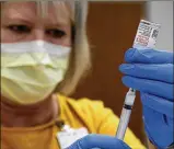  ?? BILL LACKEY / STAFF ?? Nurse Lynn DiLoreto draws up a Moderna COVID-19 vaccine dose Wednesday at the Champaign County vaccine distributi­on site at the Champaign County Government Center.