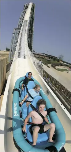  ?? Charlie Riedel/Associated Press ?? In this photo taken with a fisheye lens, riders go down the world’s tallest water slide called “Verruckt” at Schlitterb­ahn Waterpark in 2014 in Kansas City, Kan.